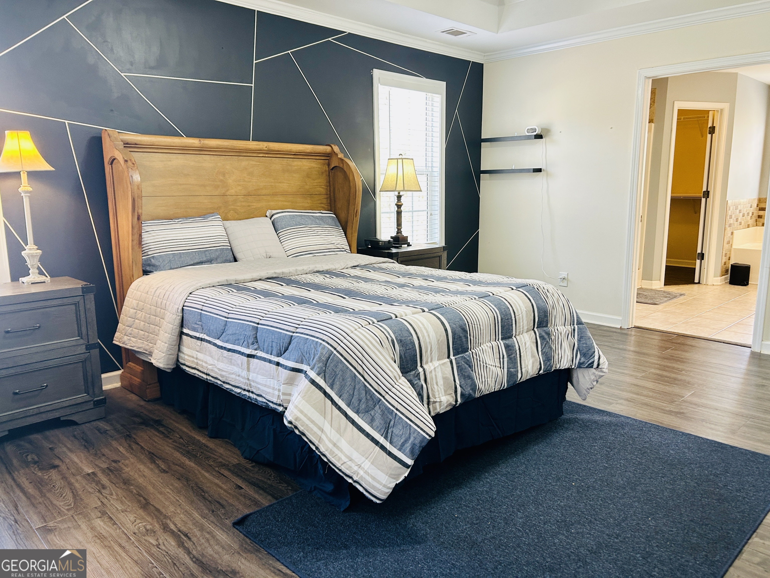 129 Rockwind Way Demorest, GA 30535 - Photo 22 of 45 a bedroom with a bed and wooden floor