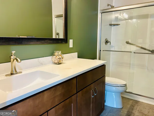 a bathroom with a sink vanity and a mirror