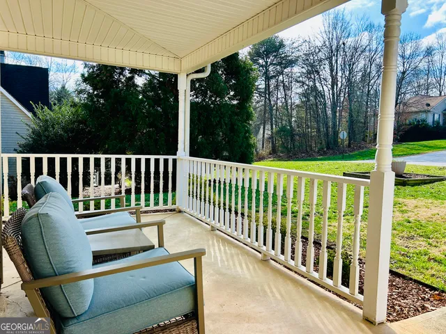 a view of a balcony with two windows