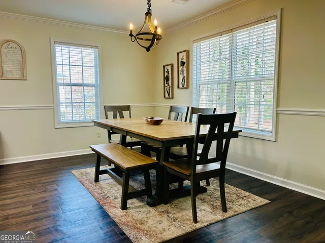 a view of a dining room with furniture wooden floor and chandelier