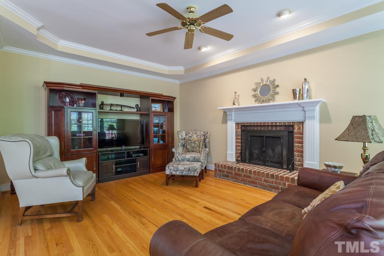 2408 Wertherson Lane Raleigh, NC 27613 - Photo 7 of 25 a living room with furniture and a fireplace