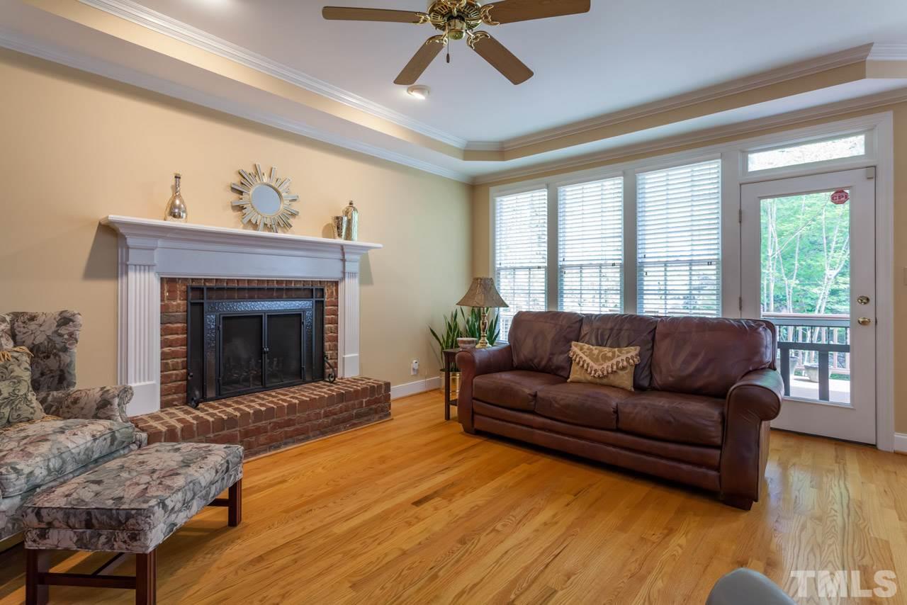 2408 Wertherson Lane Raleigh, NC 27613 - Photo 8 of 25 a living room with furniture and a fireplace