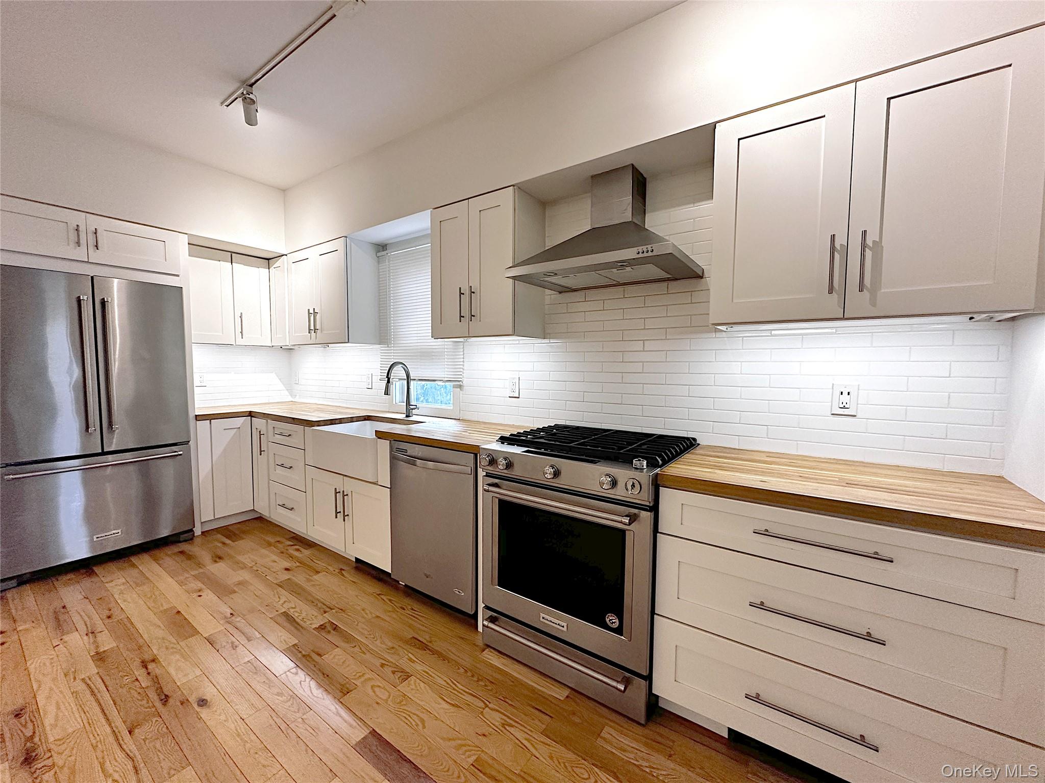 a kitchen with a white cabinets and white appliances