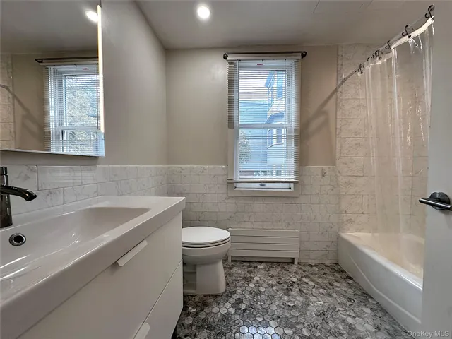 a view of a room with wooden floor and fan