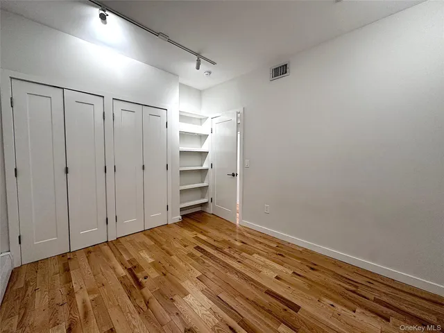 a view of room with wooden floor