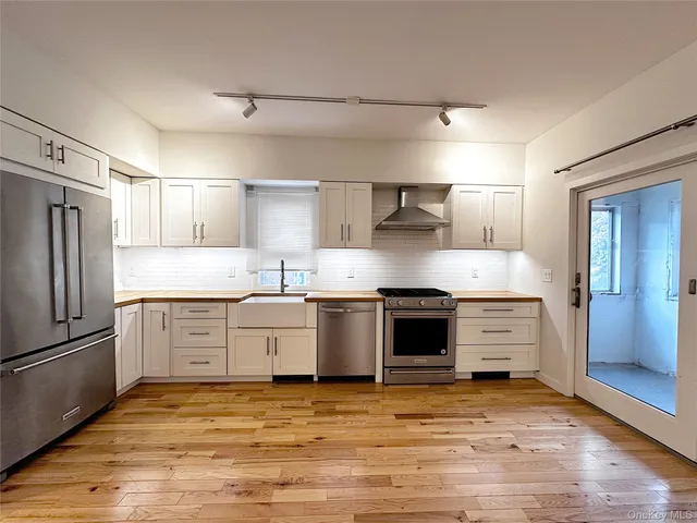 a view of kitchen with sink and wooden floor