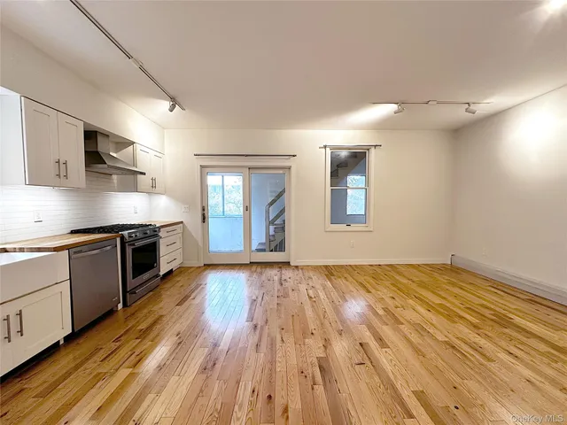 a kitchen with stainless steel appliances a refrigerator sink and cabinets