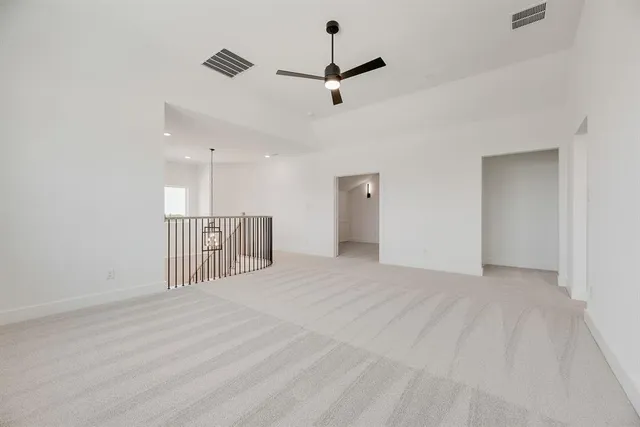 a view of an empty room with a ceiling fan