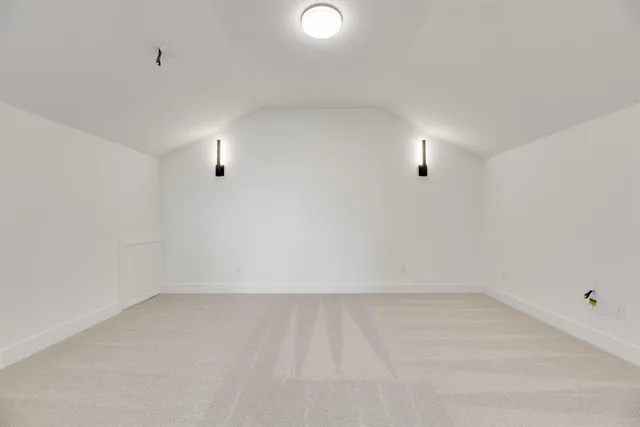 an empty room with white walls and windows