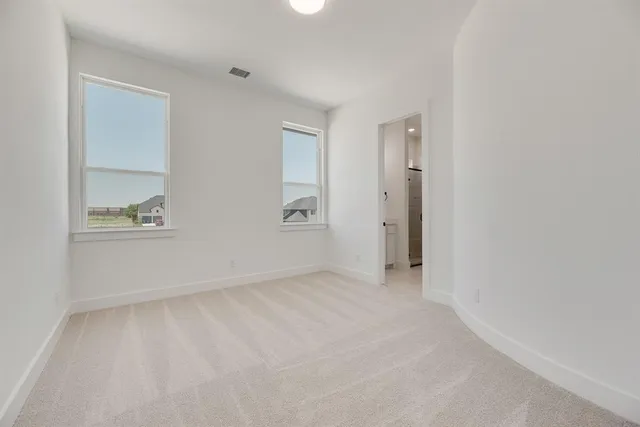 an empty room with windows and closet