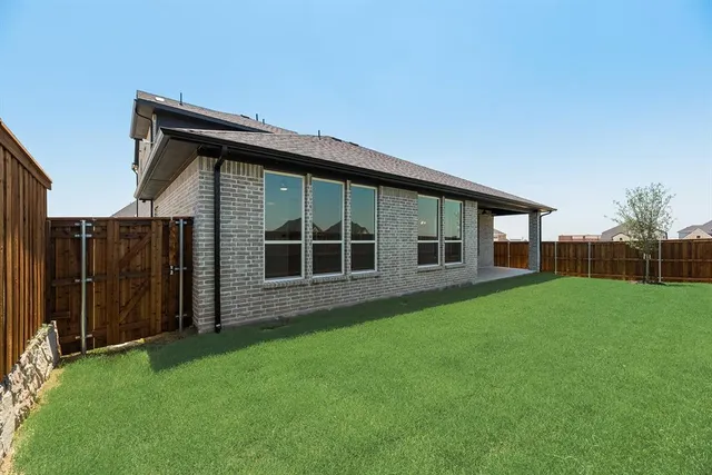 a backyard of a house with wooden fence