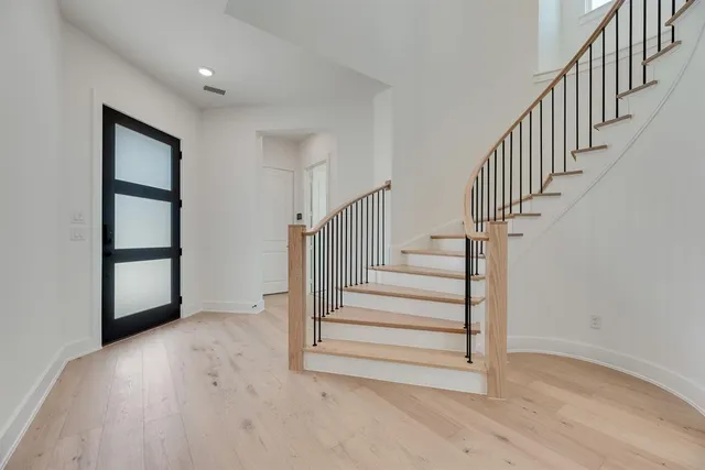 a view of entryway and hall with wooden floor