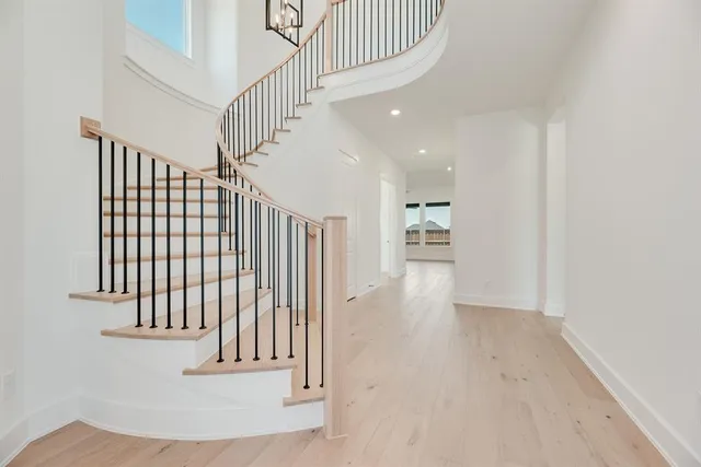 a view of entryway and hall with wooden floor