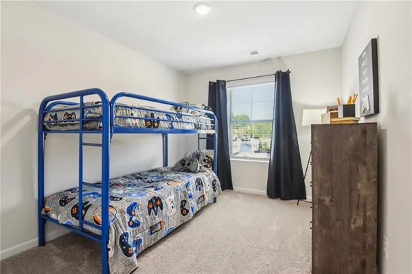 a bedroom with a bed next to a window