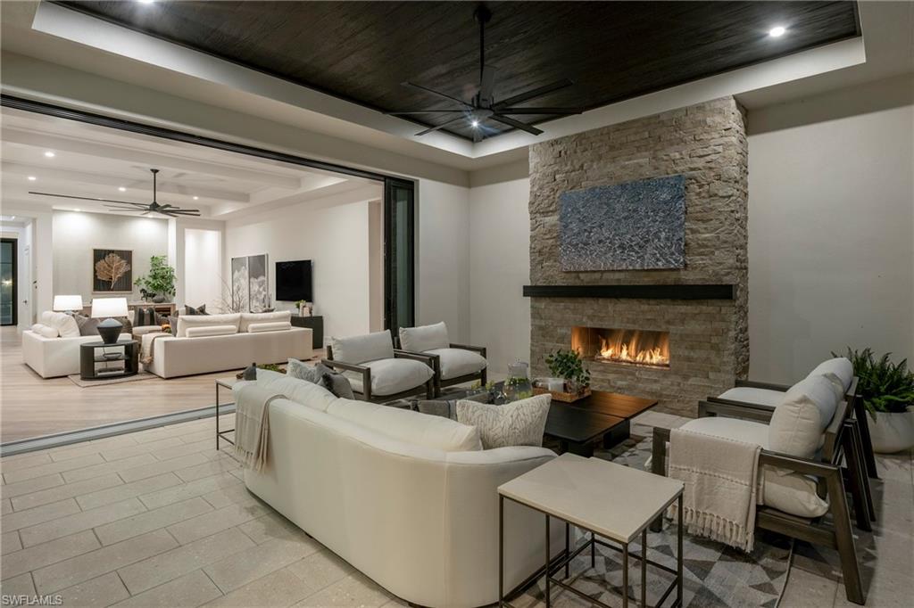 6704 Newport Road Naples, FL 34109 - Photo 36 of 47 a living room with furniture and a fireplace