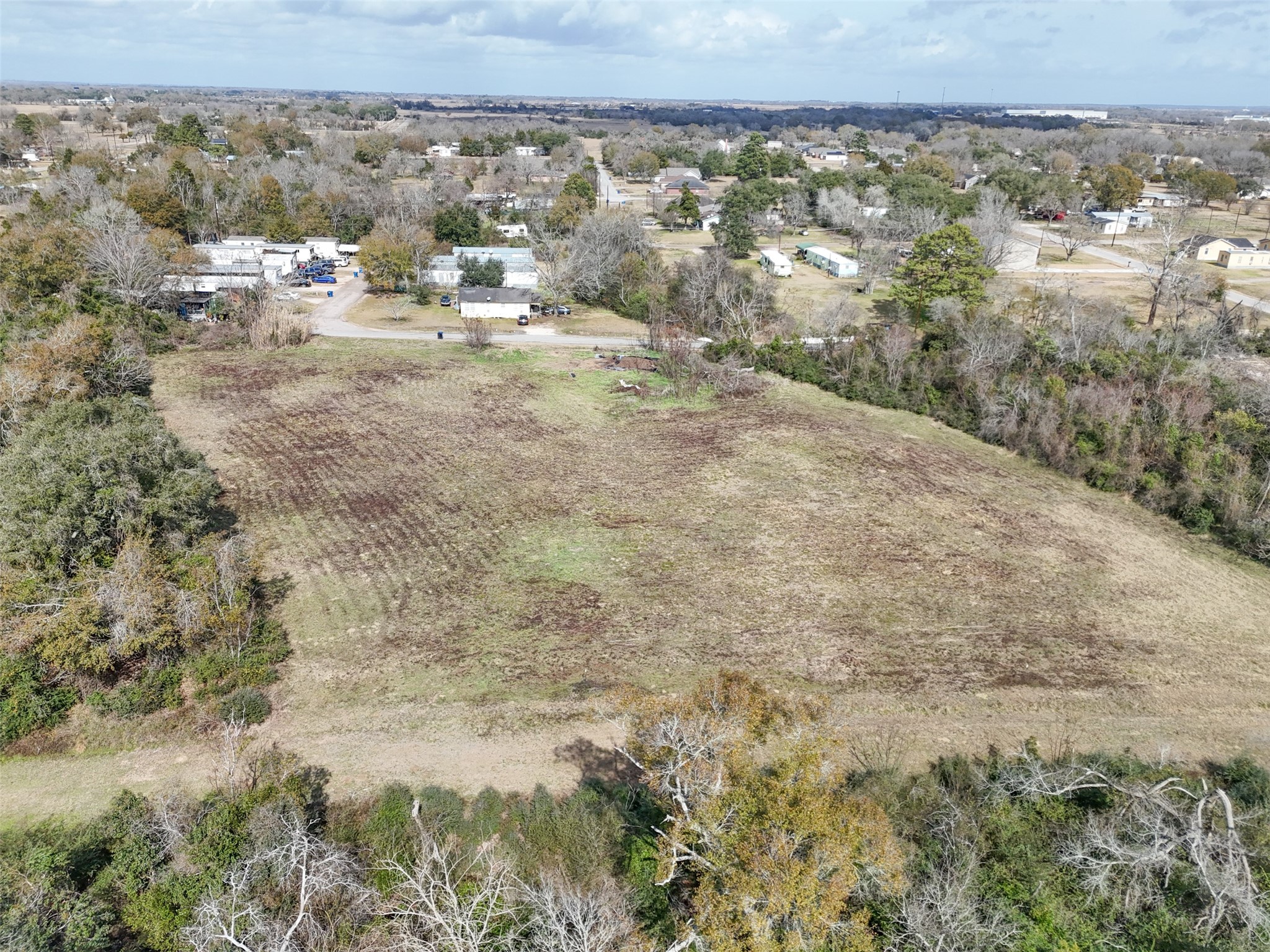 Tbd Tbd 22nd Hempstead, TX 77445 - Photo 15 of 20 Aerial view showcasing a broad, cleared tract bordered by mature trees, offering a strong sense of space and natural separation from surrounding homes.