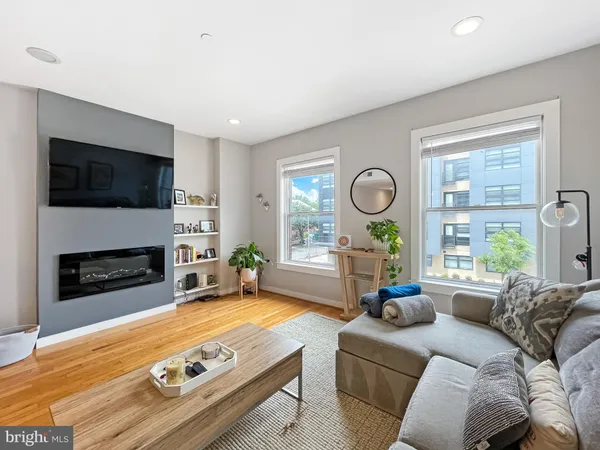a living room with furniture a fireplace and a flat screen tv