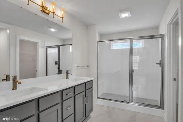 a bathroom with a sink double vanity and a shower