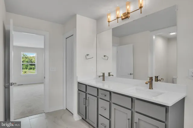 a bathroom with a sink double vanity and a mirror