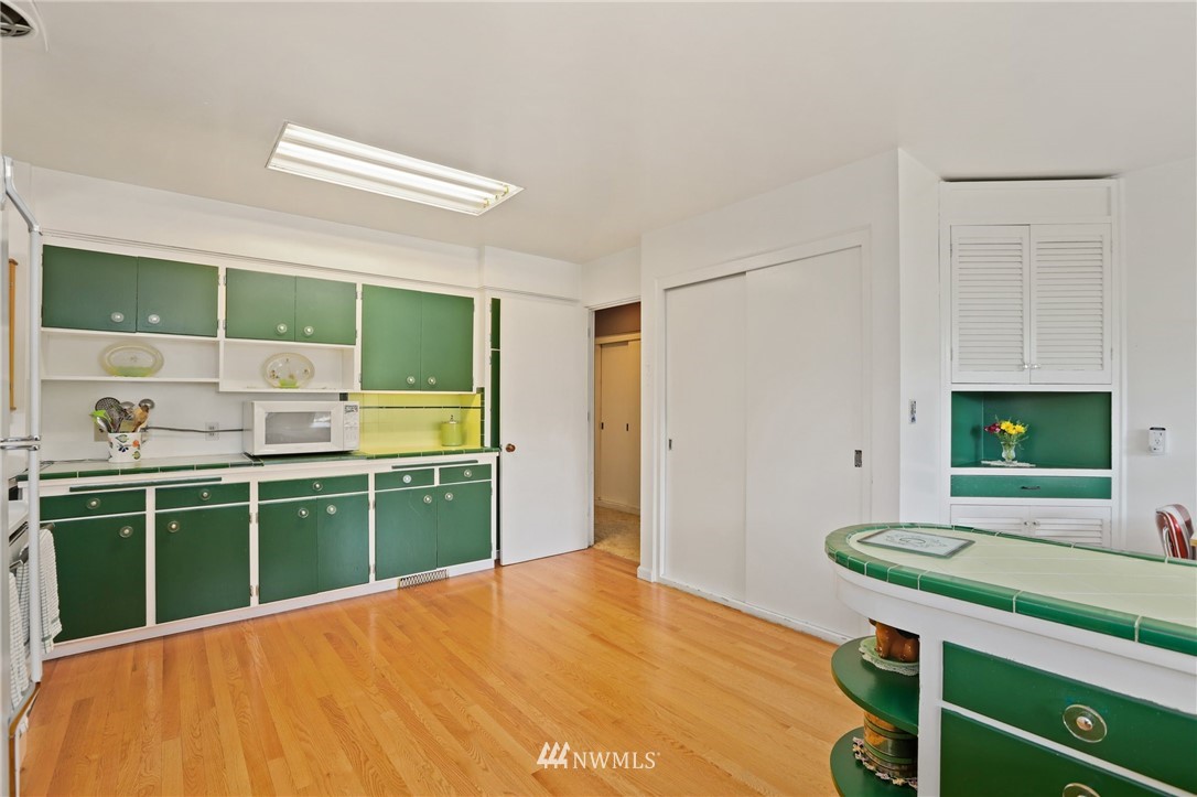 831 Rucker Avenue Everett, WA 98201 - Photo 12 of 40 a kitchen with a sink and wooden cabinets