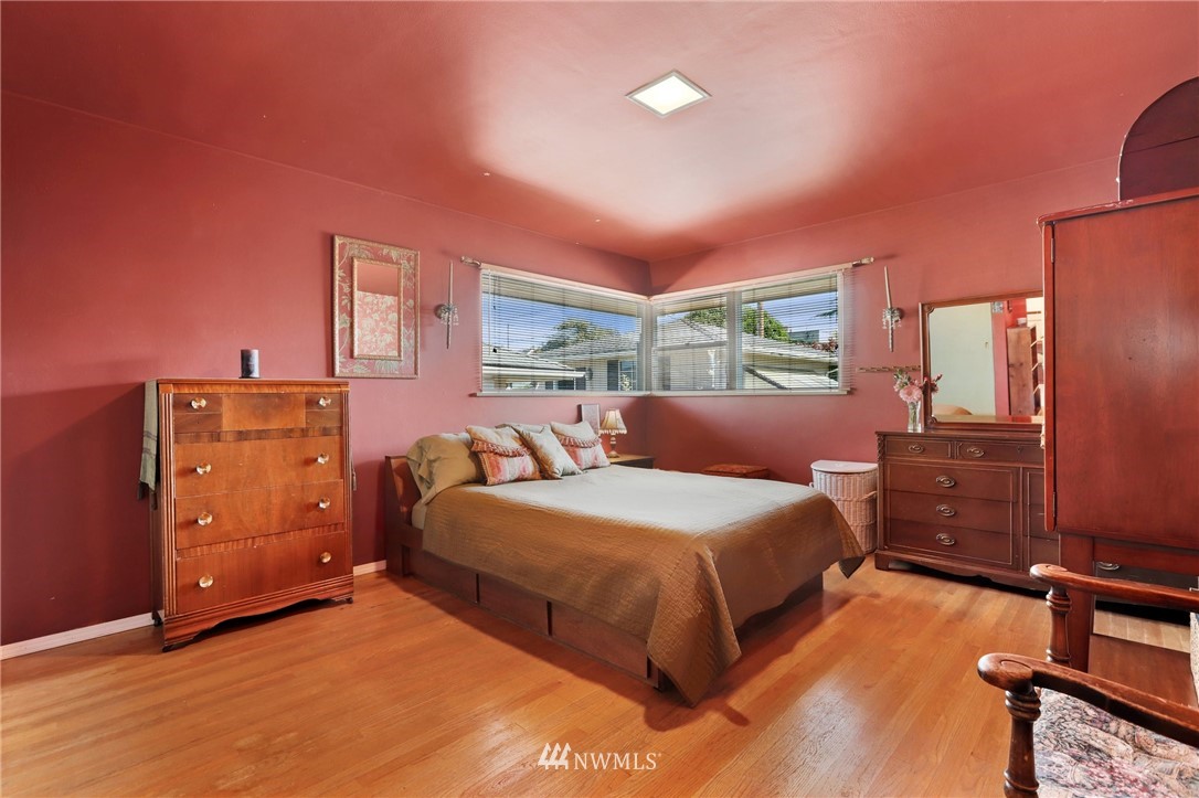 831 Rucker Avenue Everett, WA 98201 - Photo 15 of 40 a bedroom with a bed and wooden floor