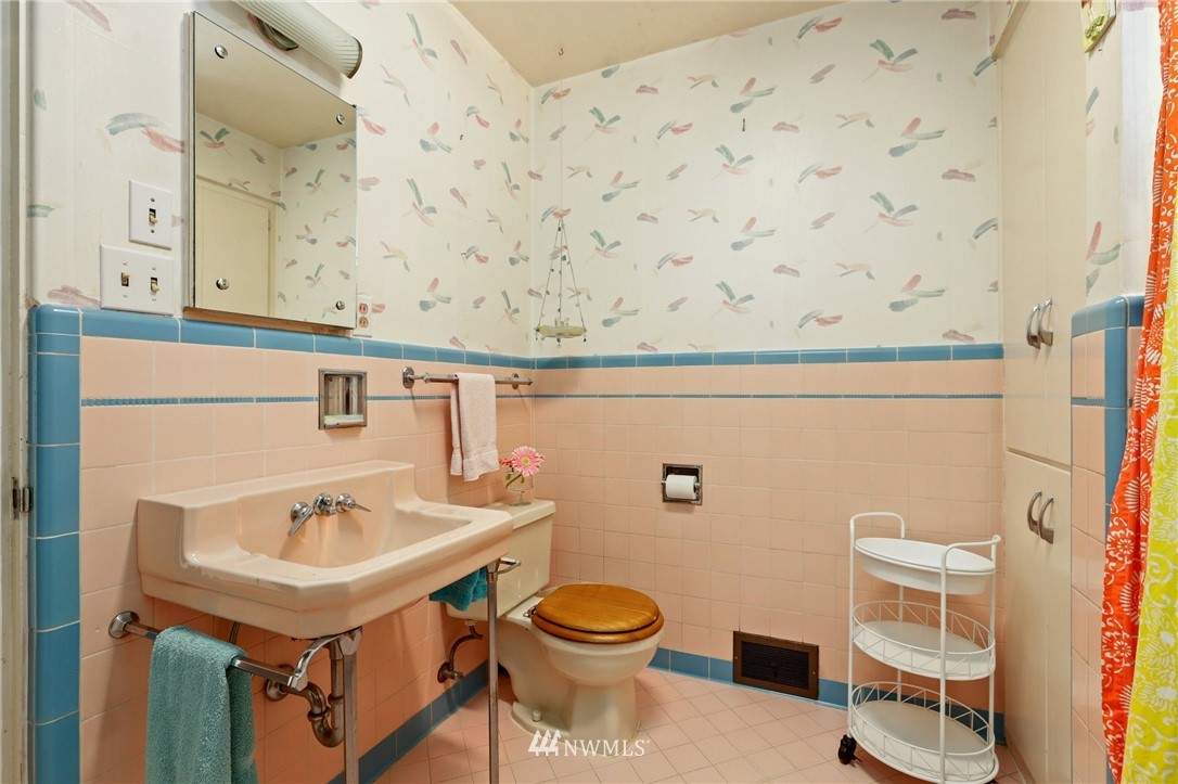 831 Rucker Avenue Everett, WA 98201 - Photo 21 of 40 a bathroom with a sink a toilet and mirror