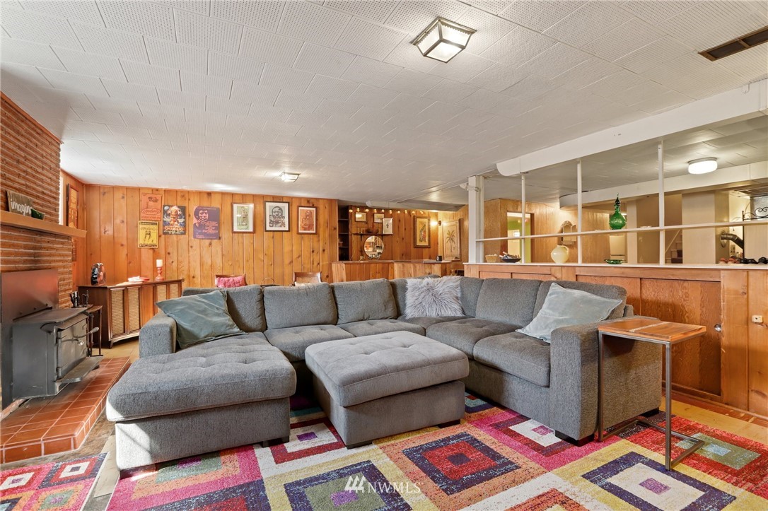831 Rucker Avenue Everett, WA 98201 - Photo 25 of 40 a living room with furniture and a flat screen tv