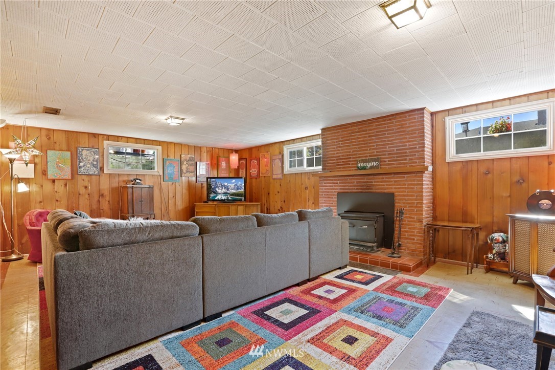 831 Rucker Avenue Everett, WA 98201 - Photo 26 of 40 a living room with furniture a rug and a fireplace