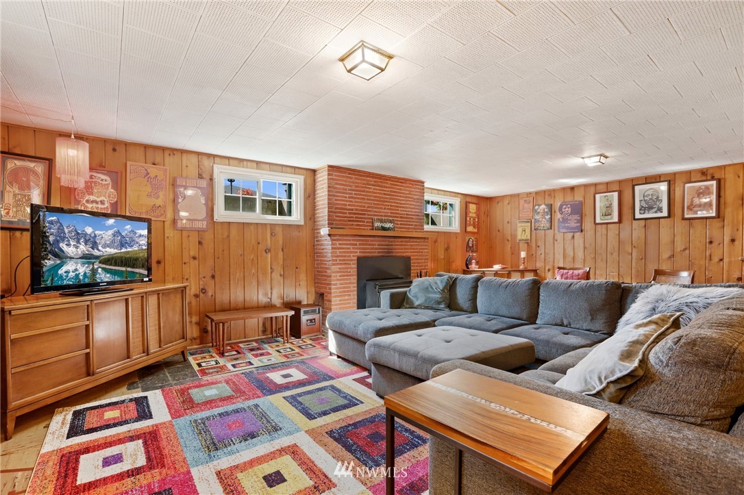 831 Rucker Avenue Everett, WA 98201 - Photo 27 of 40 a living room with furniture and a flat screen tv