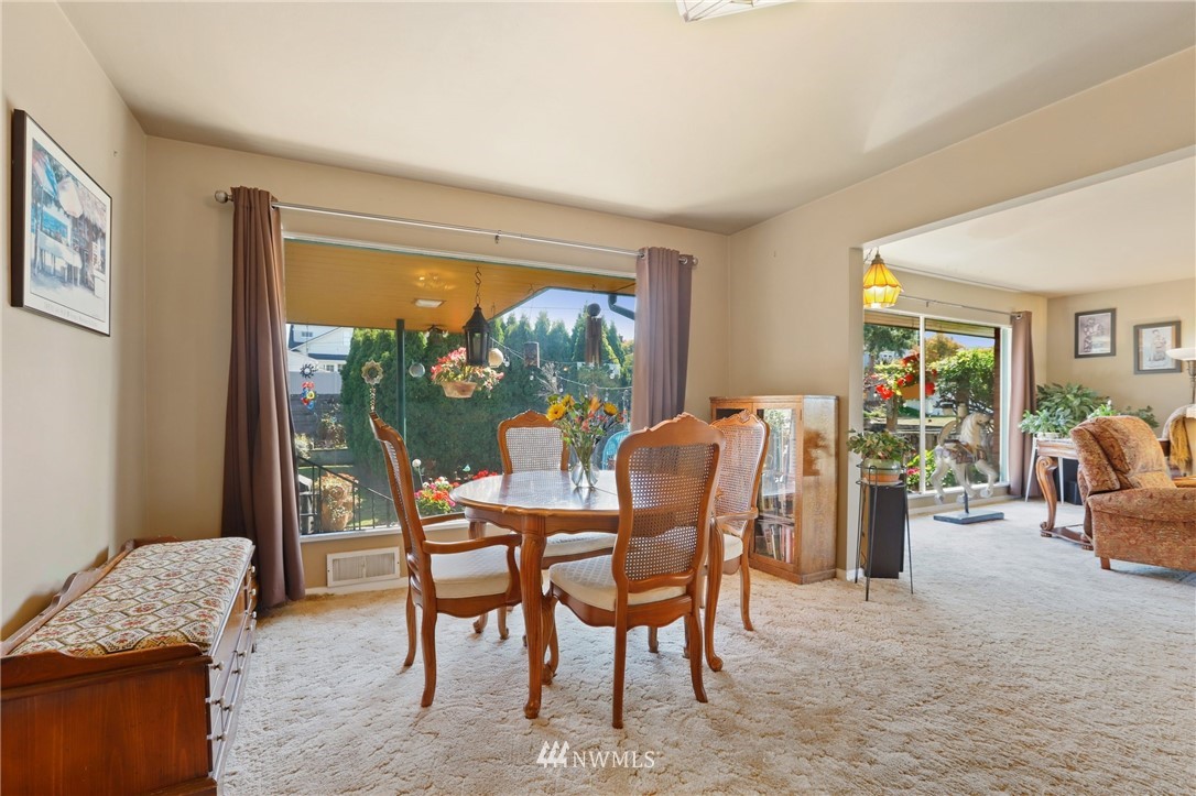 831 Rucker Avenue Everett, WA 98201 - Photo 7 of 40 a dining room with furniture and a floor to ceiling window