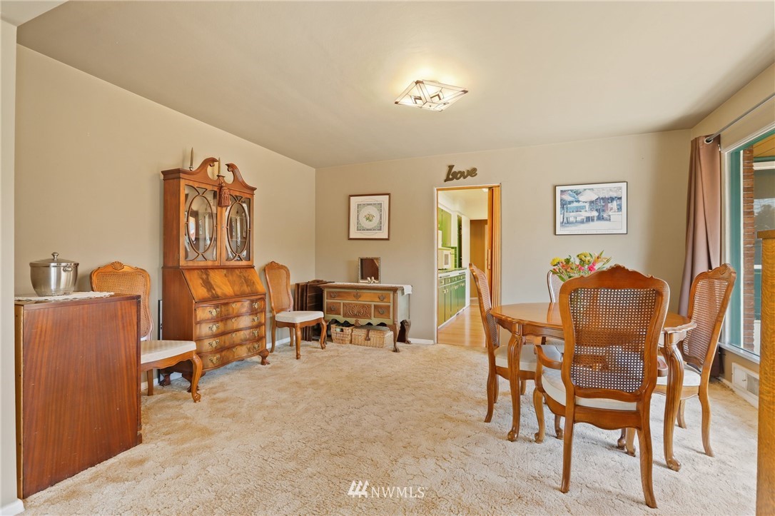 831 Rucker Avenue Everett, WA 98201 - Photo 8 of 40 a living room with furniture and a dining table with bookshelf