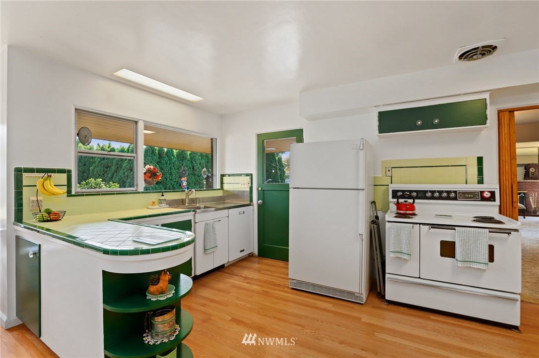 831 Rucker Avenue Everett, WA 98201 - Photo 10 of 40 a kitchen with a refrigerator and a stove