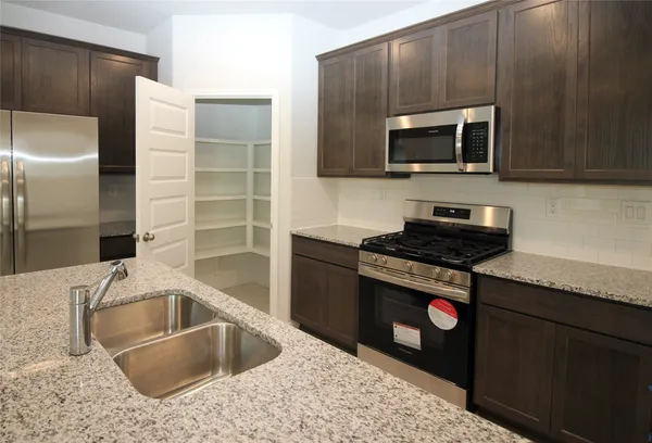 a kitchen with a sink and a refrigerator