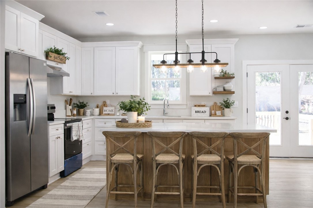 2515 Highway 29 Anderson, SC 29621 - Photo 8 of 38 A well-appointed kitchen features crisp white cabinetry, a generous island with seating, and bright views to the outside.