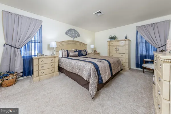 a spacious bedroom with a bed and a couch