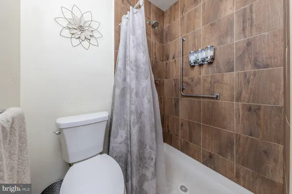 a white toilet sitting next to a shower