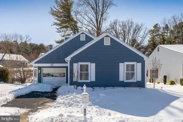 a view of a house with a yard covered in snow