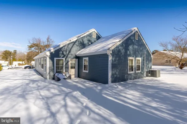 a view of a house with a snow in the yard