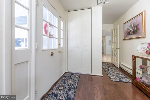 a view of an entryway with wooden floor