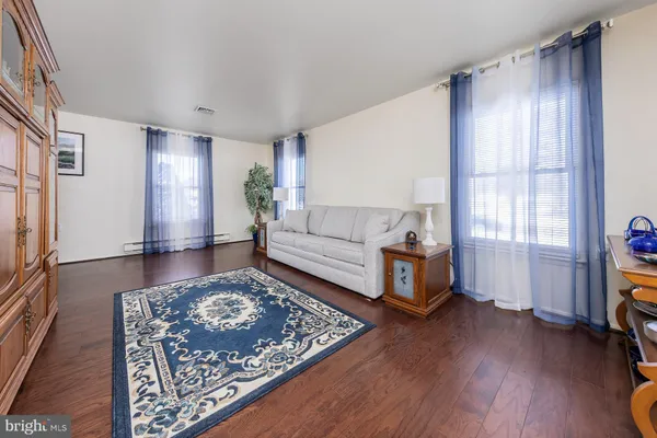 a living room with furniture and a rug
