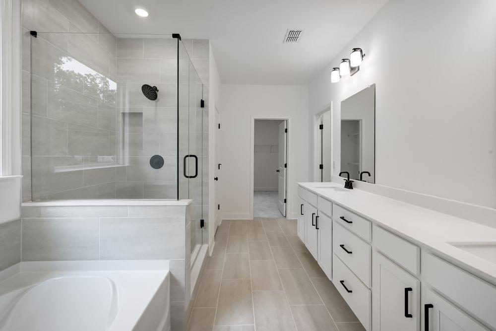 2311 Ellie Way Kennesaw, GA 30152 - Photo 15 of 35 a bathroom with a double vanity sink a large mirror and shower