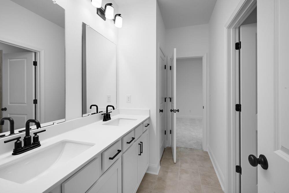 2311 Ellie Way Kennesaw, GA 30152 - Photo 24 of 35 a bathroom with a double vanity sink a mirror and a shower