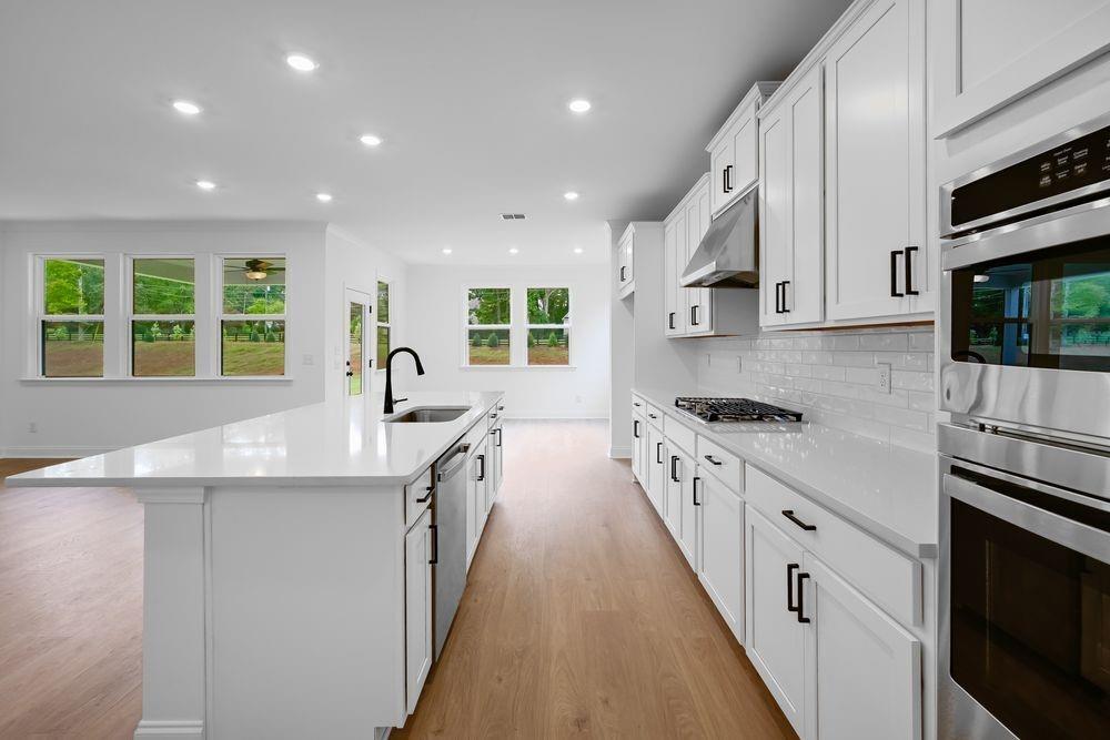 2311 Ellie Way Kennesaw, GA 30152 - Photo 5 of 35 a large kitchen with stainless steel appliances granite countertop a lot of counter space and a sink