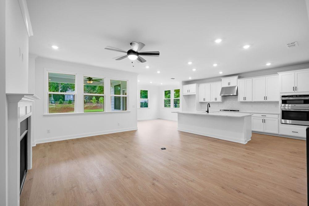 2311 Ellie Way Kennesaw, GA 30152 - Photo 8 of 35 a view of an empty room with a kitchen and a window