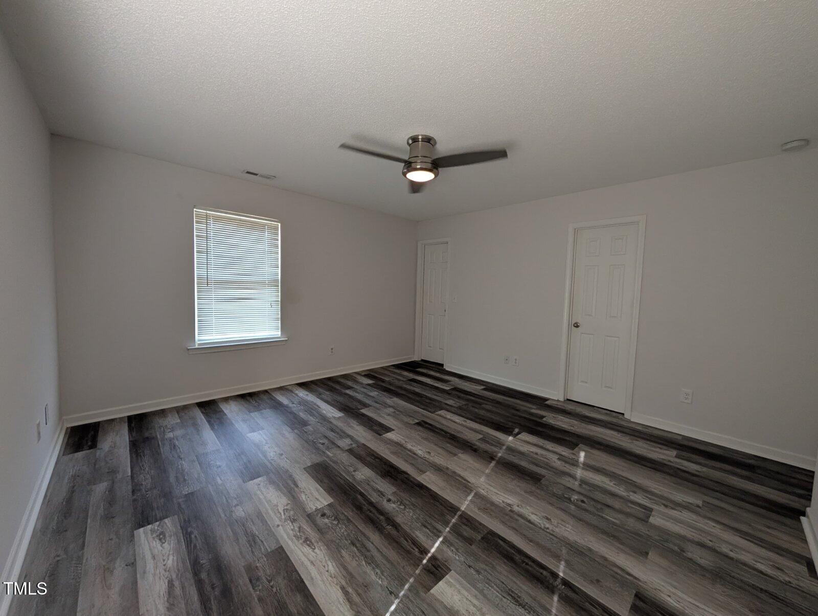 7528 Argent Valley Drive Raleigh, NC 27616 - Photo 24 of 47 a view of a room with wooden floor and a ceiling fan