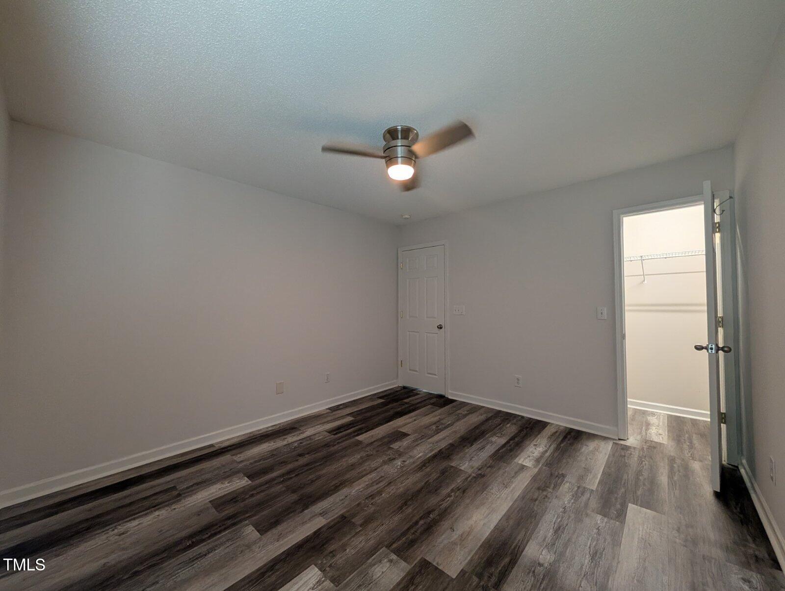 7528 Argent Valley Drive Raleigh, NC 27616 - Photo 30 of 47 a view of a room with wooden floor and a ceiling fan