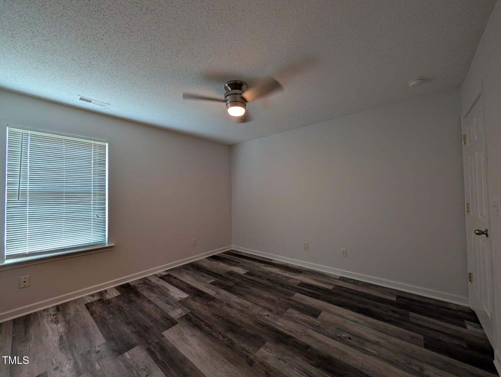 7528 Argent Valley Drive Raleigh, NC 27616 - Photo 31 of 47 a view of wooden floor and a chandelier fan in a room