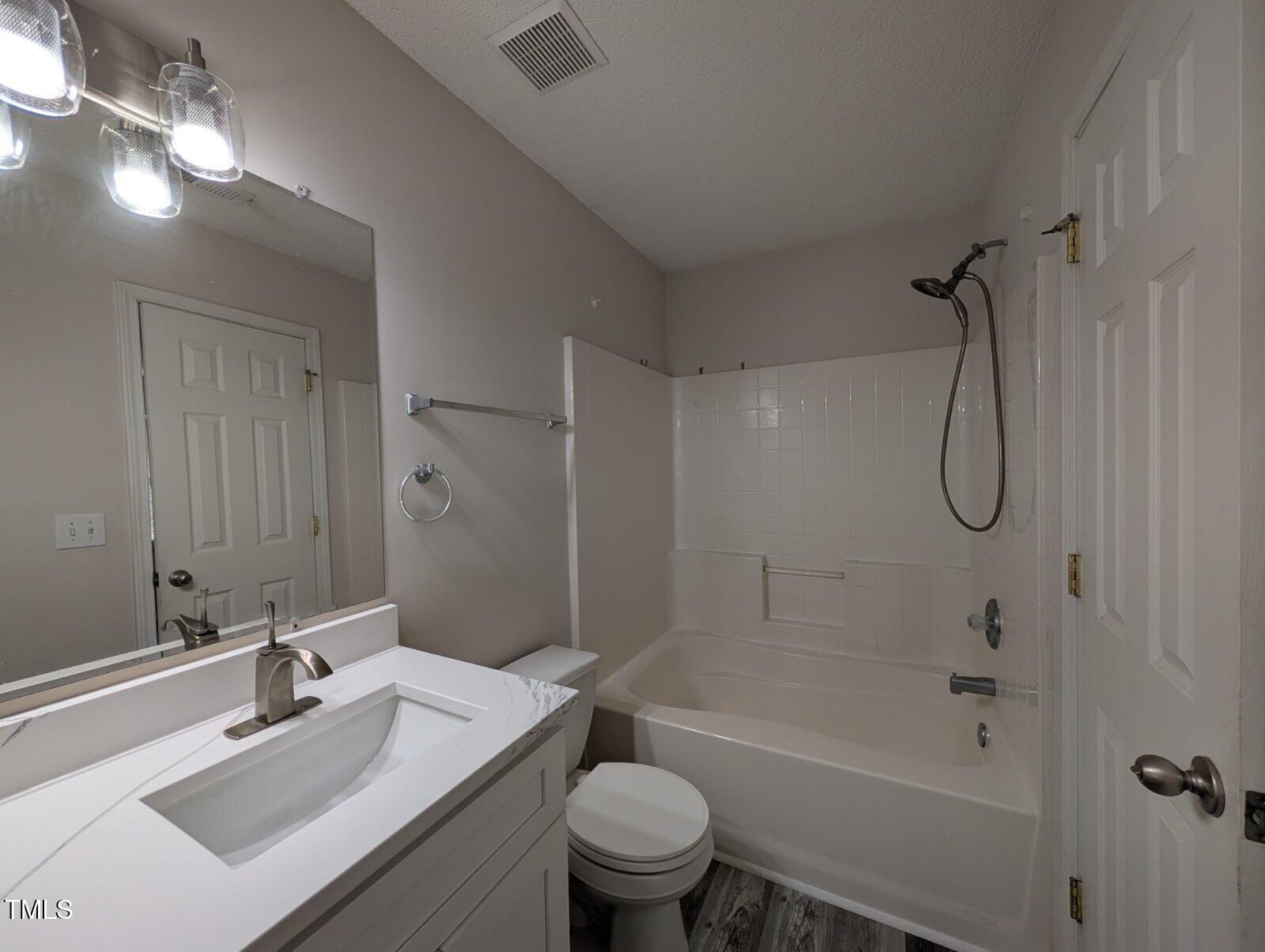 7528 Argent Valley Drive Raleigh, NC 27616 - Photo 34 of 47 a bathroom with a sink a toilet and shower