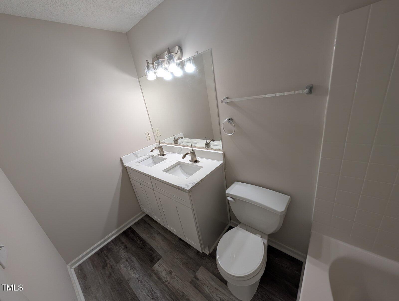 7528 Argent Valley Drive Raleigh, NC 27616 - Photo 35 of 47 a bathroom with a toilet sink and mirror