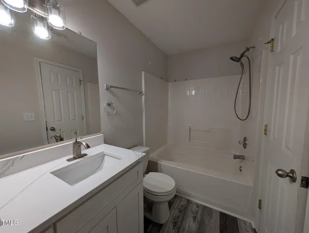 a bathroom with a sink toilet tub and shower
